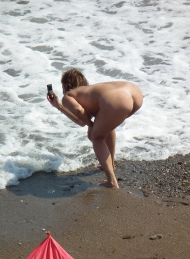 Topless in bikini and nude young candid beach hotties